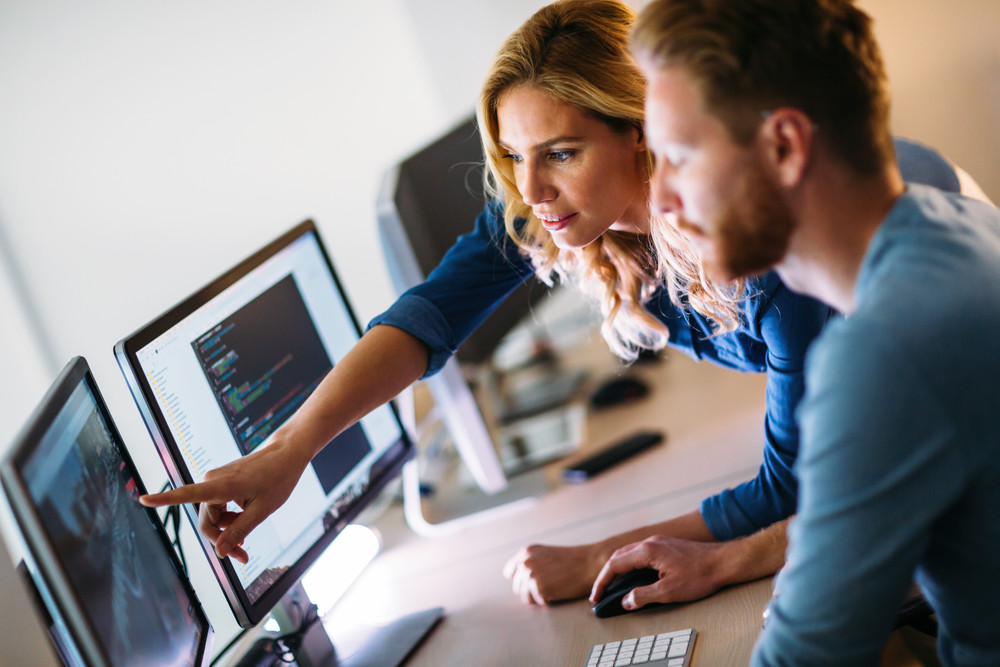 two people working on a computer